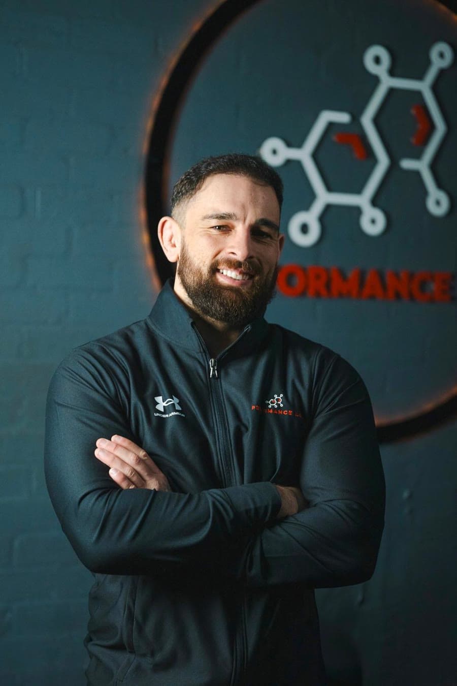 Daniel Gulsher, founder and CEO of GymFront, standing with arms crossed in his gym
